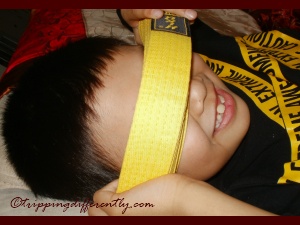 He's being goofy with his brand new yellow belt.