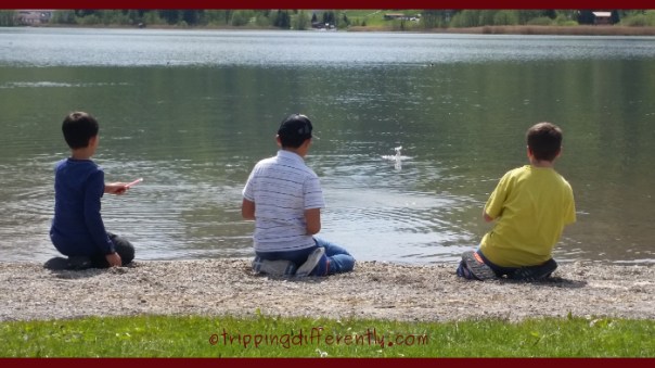 i love this shot of them, trying to skip stones on the lake.